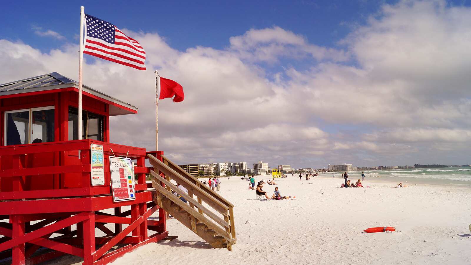 Siesta Beach's red lifeguard stand on the white quartz sand of Siesta Key.